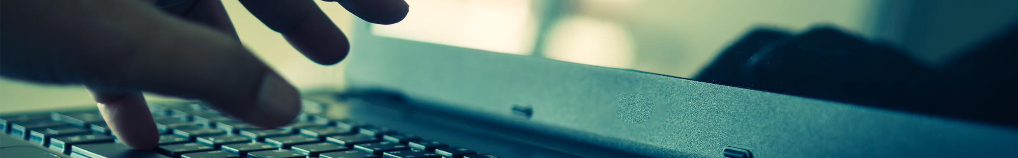 close up of laptop keyboard and hands