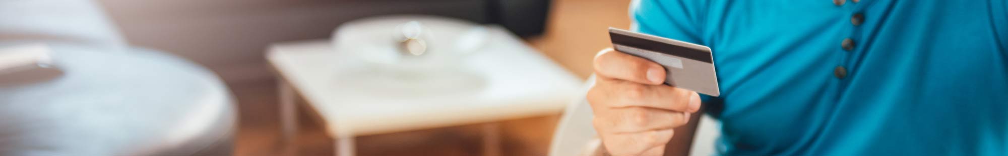 close up of a hand holding a credit card