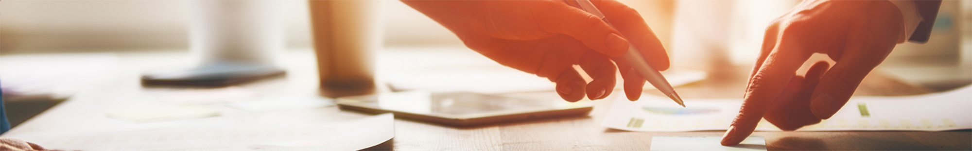 close-up of hands pointing at financial documents