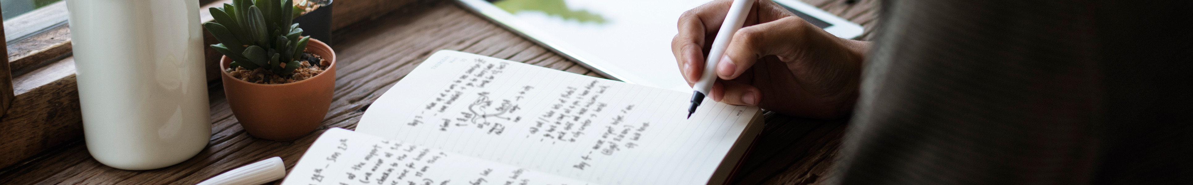 woman journaling at a desk