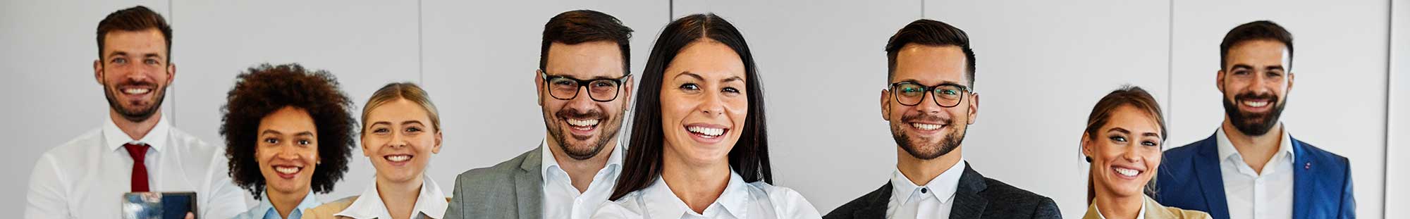 eight business people smiling at the camera