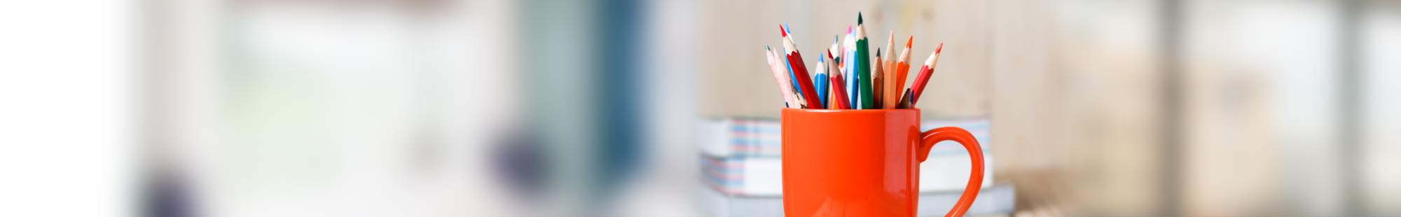 coffee mug full of colored pencils