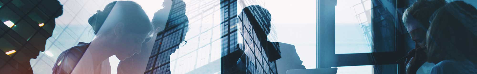 people working together in the glare of a building