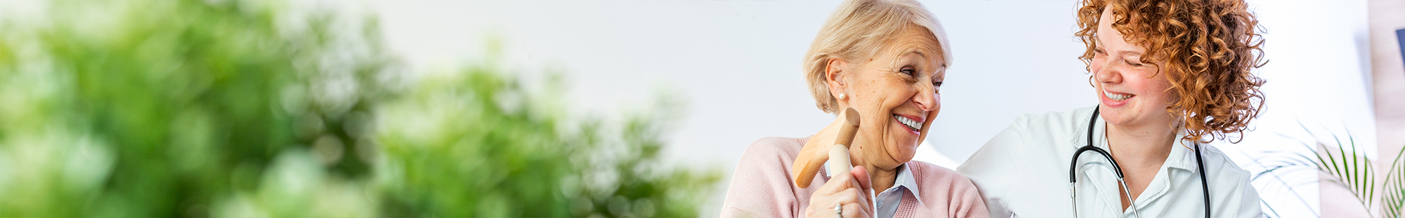 older woman smiling over her shoulder at her doctor