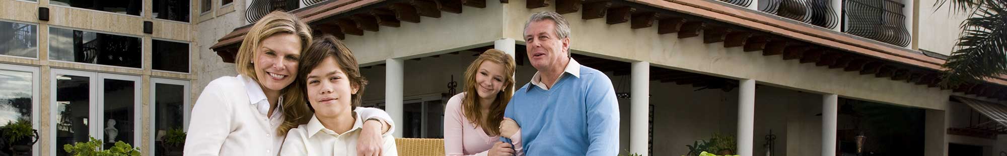 a family in front of a large house