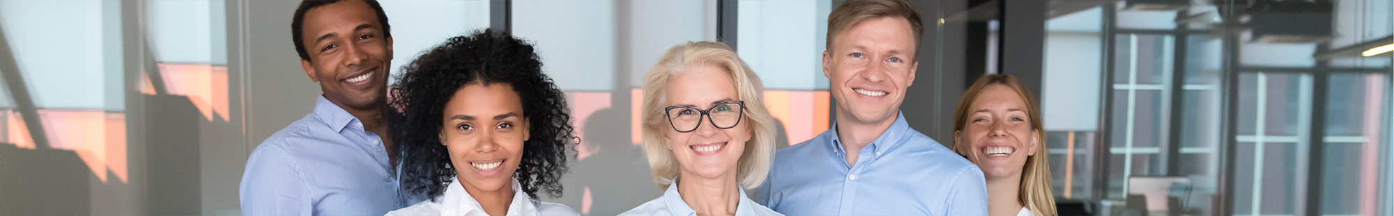 smiling mature woman boss with diverse workers group employees looking at camera